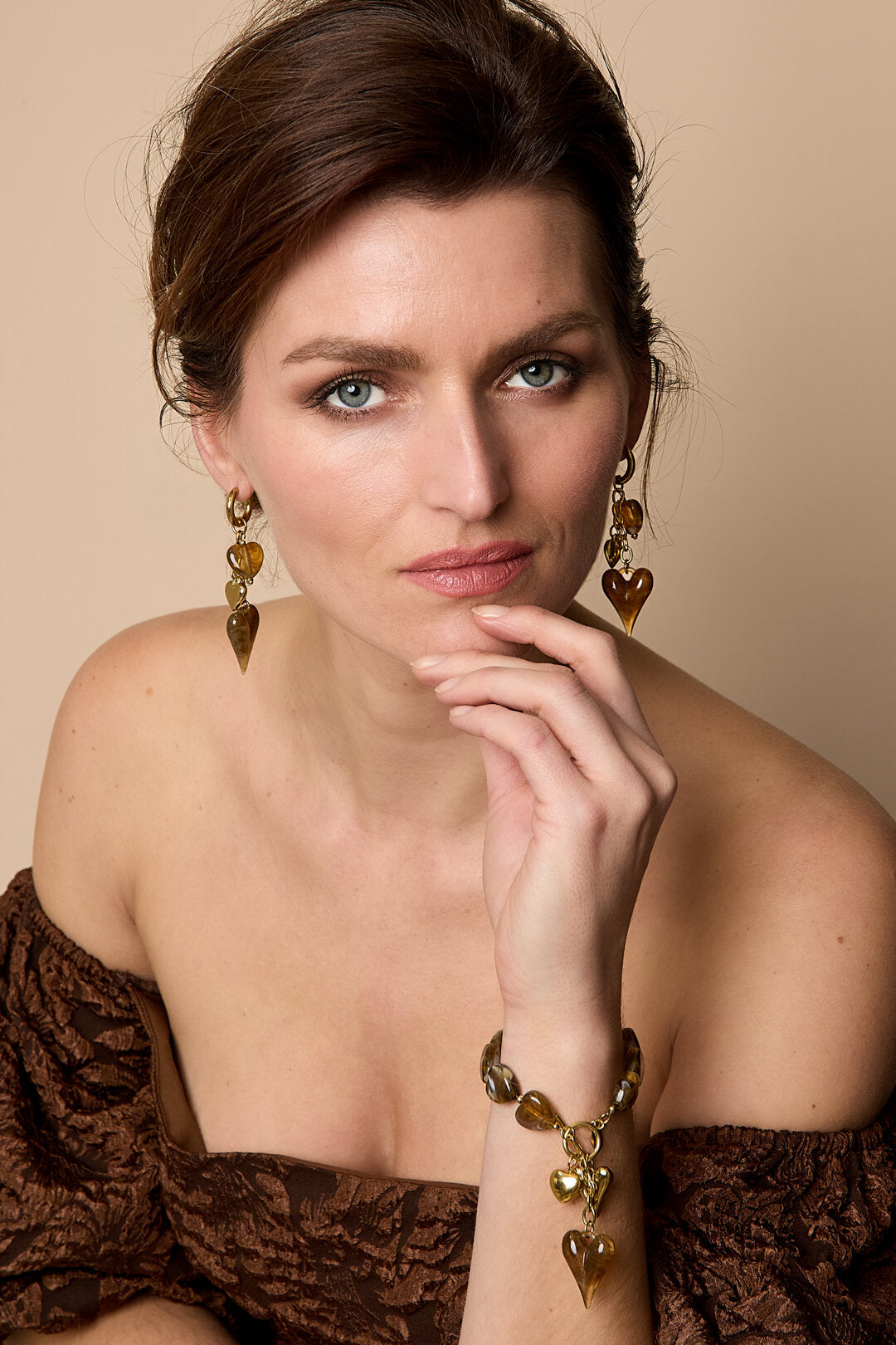 Earrings with dangling hearts on a chain